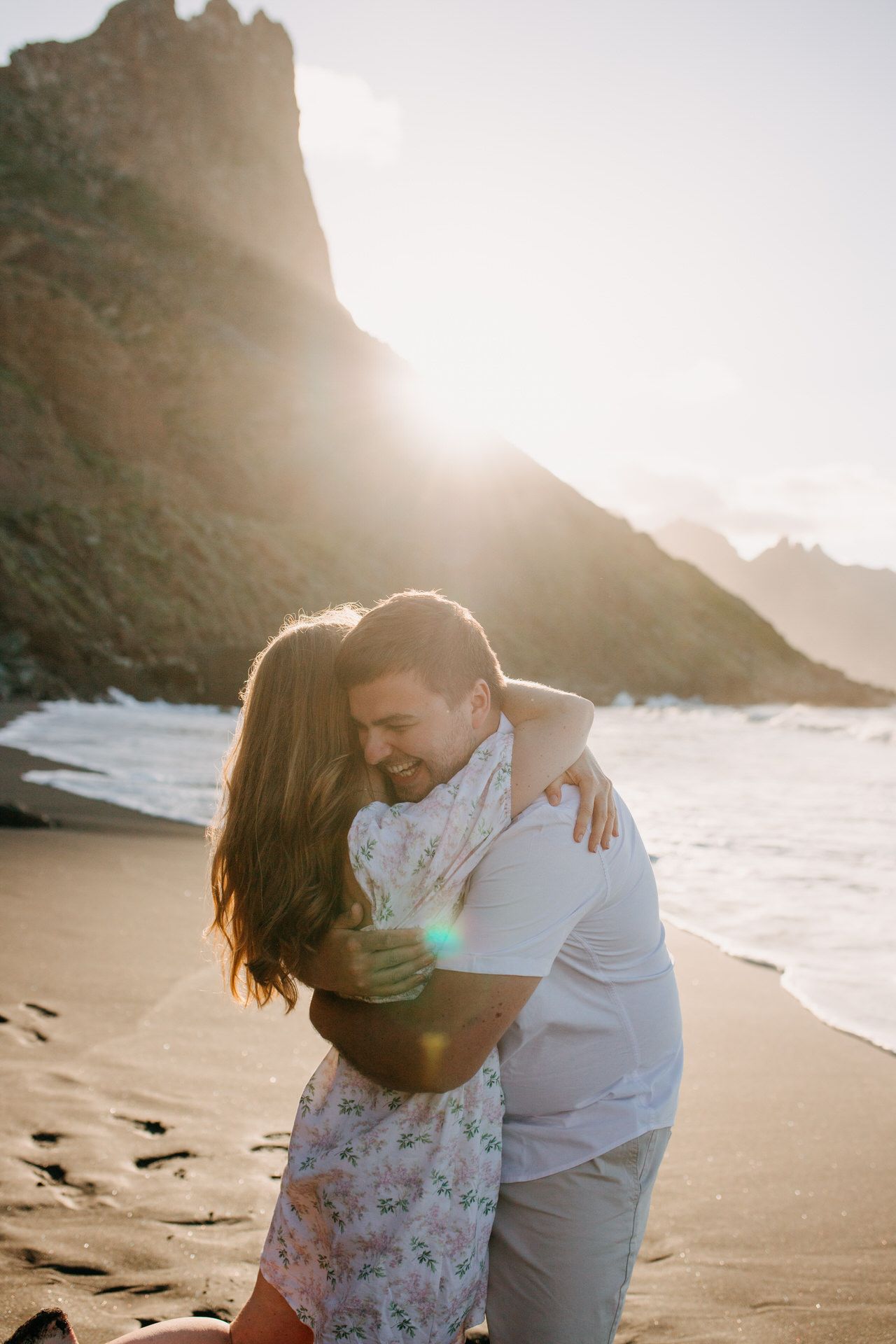 Freshly engaged couple hugging at the beach in Tenerife